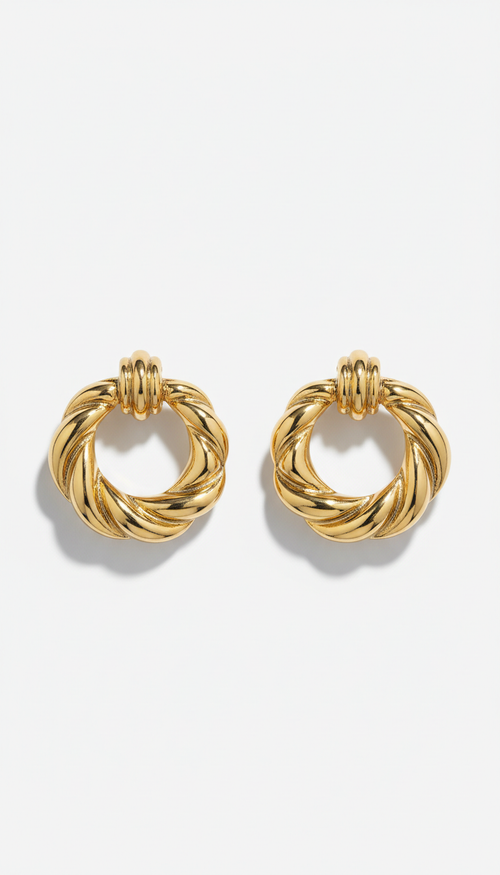 Gilded gold statement hoop earrings, perfectly centered horizontally and vertically with equal negative space above and...