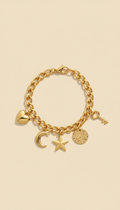 Gold-plated charm bracelet, 3/4 angle close-ups on textured surfaces (e.g., linen over wood). Products artfully arranged...